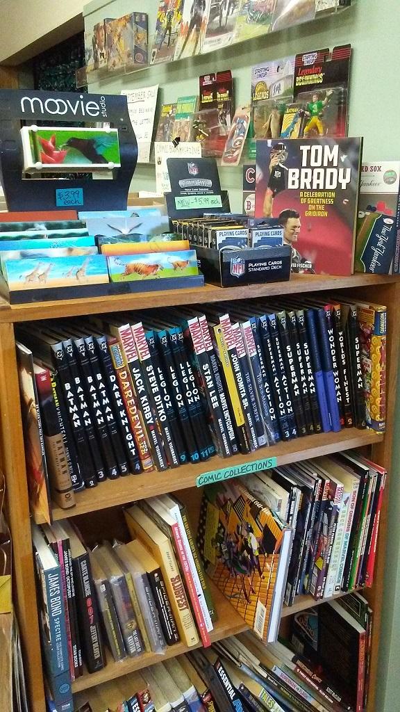Comic books and hardcover collections on the shelf