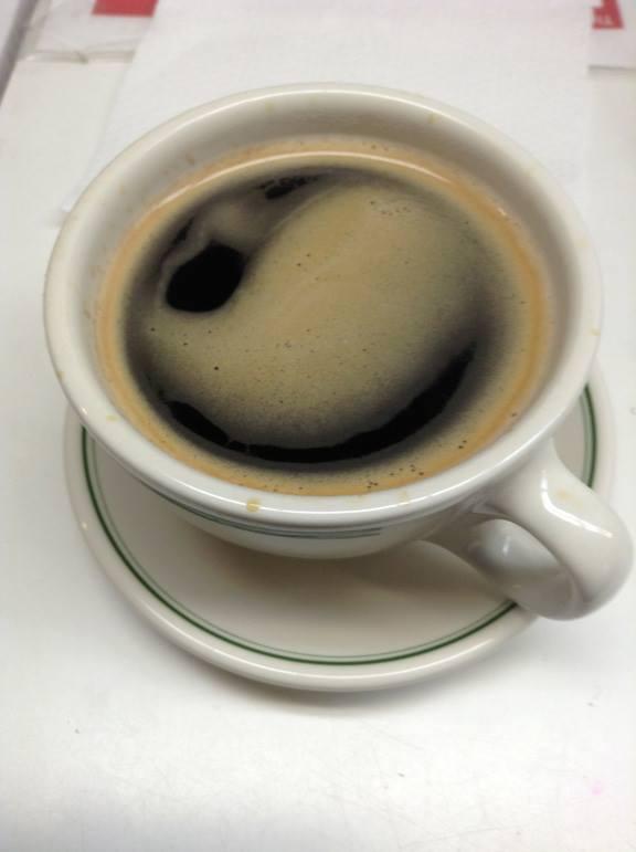 A cup of espresso with a golden crema